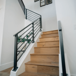 Wooden staircase with sleek black railings