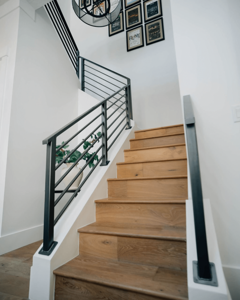 Wooden staircase with sleek black railings