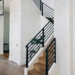 Wooden staircase with sleek black railings
