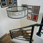 Wooden staircase with sleek black railings.
