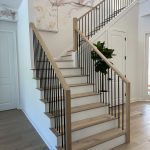Contemporary indoor staircase with sleek wooden steps and metal railing