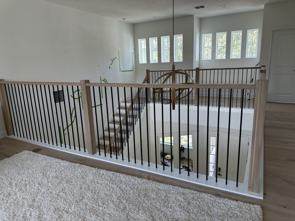 Contemporary indoor staircase with sleek wooden steps and metal railing