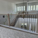 Contemporary indoor staircase with sleek wooden steps and metal railing
