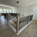 Contemporary indoor staircase with sleek wooden steps and metal railing
