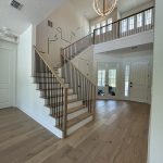 Contemporary indoor staircase with sleek wooden steps and metal railing