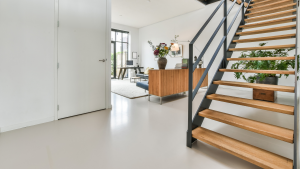 Modern open staircase with wood treads and black metal railings in a bright, minimalist Florida home.
