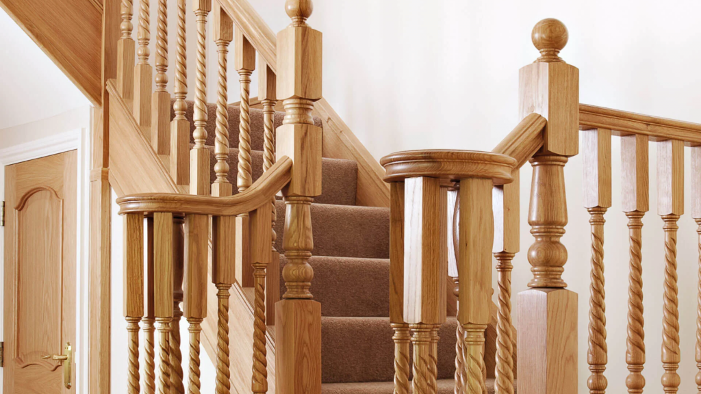 Oak handrails with turned and twisted balusters on a traditional staircase.