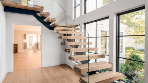 Modern minimal staircase style with floating treads and a clear glass balustrade