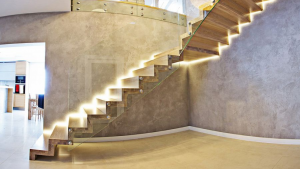 Luxe contemporary staircase style featuring glass, concrete, and dramatic lighting