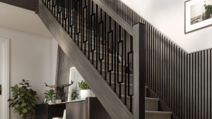 Modern black staircase with custom metal balusters, dark wood handrail, and contemporary wall paneling in a stylish home interior.